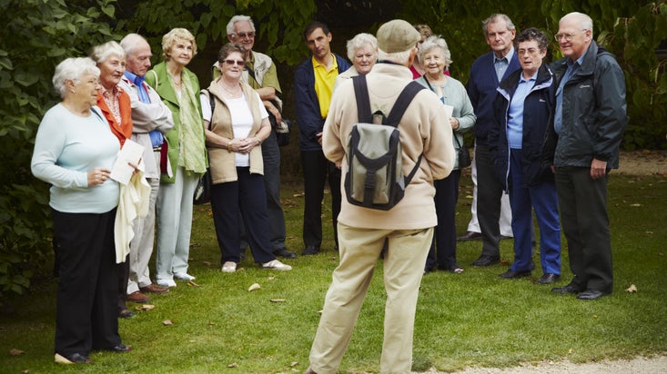 Visitors on a guided group tour with a volunteer guide at Hidcote Manor Garden, Gloucestershire in September